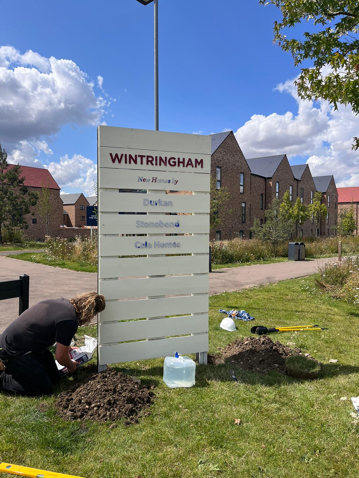 Sustainable timber totem sign with acrylic text.